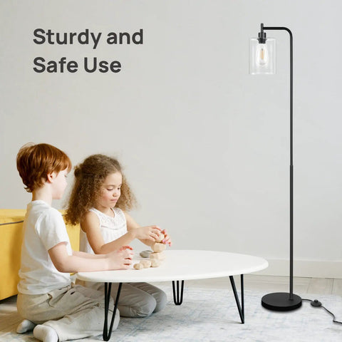 Industrial LED Floor Lamp With Hanging Glass Shade, ST64 9W Vintage Filament Bulb near children playing in living room.