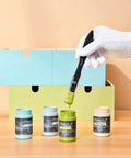 Chalk Furniture Paint Set With Nine Colors In Ultra Matte Finish, 60 Ml Bottles, Includes Liquid Wax, 2 Brushes, 3 Sandpapers, shown with brush.