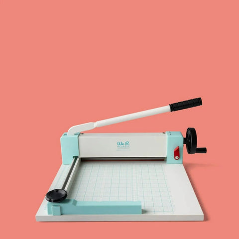 Heavy Duty Guillotine Paper Cutter for 1 Inch Thick Stacks with Easy Operation and Precision Alignment on display against coral background.