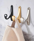 Sleek Wall Mount Coat Rack Built With Rock Solid Zinc Alloy Hooks Perfect For Mudrooms And Halls displaying black, gold, and silver hooks.