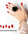 Semi Cured Gel Nail Strips Kit 20PCS for DIY Manicure in red on a hand with black flower ring