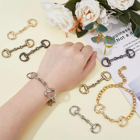 8 Pack Alloy D Ring Snaffle Bit Buckles, Four Color Variety For DIY Horse Jewelry, Shoe And Accessory Craft displayed on table