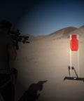 Shooter aiming at 12x24 C Zone Self Healing Silhouette Target for pistol and rifle training on outdoor range