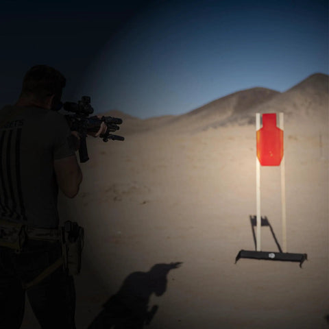 Shooter aiming at 12x24 C Zone Self Healing Silhouette Target for pistol and rifle training on outdoor range