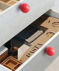 Bold Red Ceramic Dresser Knobs Six Pack Smooth Drawer Pulls on kitchen drawer with pasta packets and utensils visible.