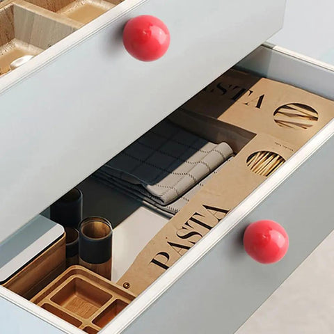 Bold Red Ceramic Dresser Knobs Six Pack Smooth Drawer Pulls on kitchen drawer with pasta packets and utensils visible.