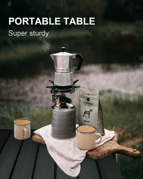 Aluminum camping table with coffee setup, featuring Foldable Aluminum Camping Table, Portable Side Desk for Beach, Hiking, Picnics, and BBQ Cooking, Lightweight, Compact Dining Surface with Carry Bag for Easy Travel and Outdoor Kitchen Use.
