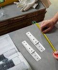Heavy Duty Hidden Headboard Wall Mount Brackets For Sofa And Couch Sections With Solid Silver Metal Connectors on a measuring table.