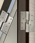 Automatic Door Closing Hinge With Lifting Mechanism Stainless Steel Self Closing Hinge Pair mounted on wood interior door.