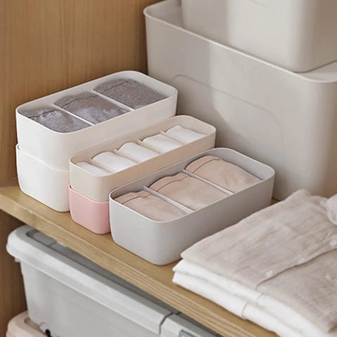 3 Piece Stackable Storage Box Set With Dividers For Bras And Leggings Multi Compartment Drawer Organizer Bin For Underwear Socks Plus Neck Ties arranged on wooden shelf with folded clothes.