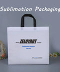 White sublimation packaging bag with black handles and text, framed floral photo and flowers in the background.