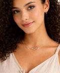 Woman wearing a necklace with silver swirl S-hook connectors, showcasing Set Of 4 S Hook Necklace Extenders With Gold And Silver Swirl Hooks.