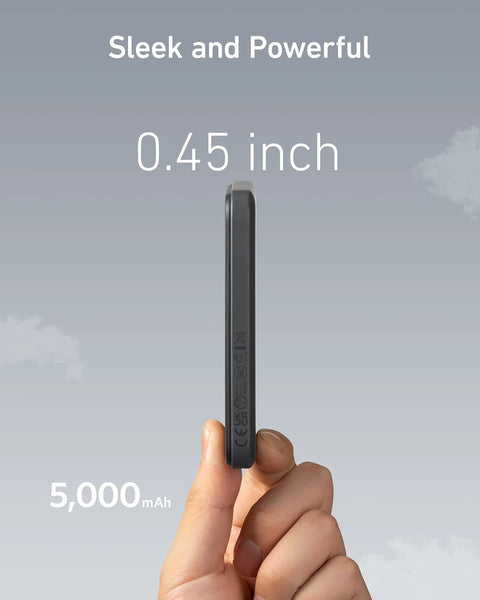 Tiny But Mighty 5000mAh Magnetic Power Bank shown from the side, 0.45 inch thick, held in hand against a cloudy sky background.