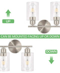 Two Light Brushed Nickel Bathroom Vanity Light With Clear Glass Shades, shown mounted facing up and down for versatility.