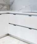 Modern kitchen with 6 Pack Finger Edge Pulls For Cabinets 80mm Length Matte Black Concealed Cabinet Handles installed on white drawers.