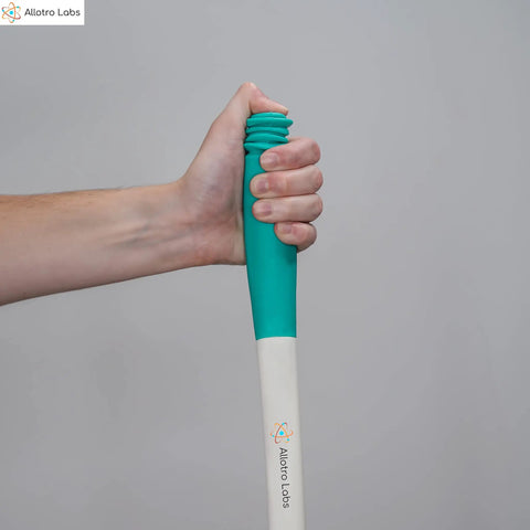 Hand holding Long Reach Toilet Wiper And Bath Brush Set For Easy Hygiene, green handle, ideal for elderly and disabled care.