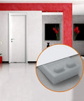 Slim Door Stopper Wedge For Bottom Of Door Non Scratch Rubber Holder in use on gray floor with a modern room background.