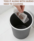 Person disposing of used Peel And Stick Shower Drain Hair Catchers 30 Pack Disposable Mesh Filters in trash bin.