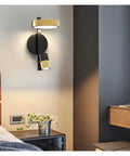 Transform Your Hangout Spot With This Sleek Nordic Iron Wall Sconce Offering A Truly Chill Warm White Glow That Is Flat Out Glare Free For Bedsides And Hallways, mounted above a bedside table.