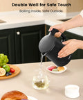 Person pouring water from Compact Electric Kettle For Tea And Coffee 0.8L 27 Oz Double Wall Stainless Steel Space Saving Mini Hot Water Heater