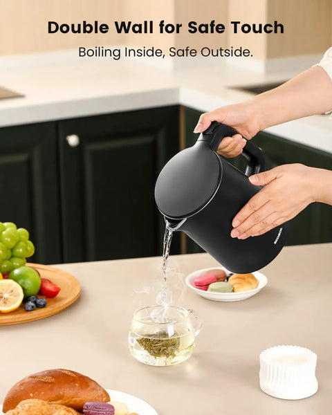 Person pouring water from Compact Electric Kettle For Tea And Coffee 0.8L 27 Oz Double Wall Stainless Steel Space Saving Mini Hot Water Heater