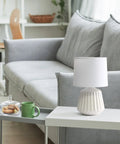 Petite Pleated Ceramic Table Lamp With Off White Fabric Shade 5 Ft Cord 40W Equivalent Type B Bulb Not Included Classic English Style Accent Light For Bedroom Or Living Room Cozy Glow on white table next to green mug