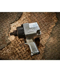 Badass 3/4 Inch Drive Air Impact Wrench Delivering Straight Up 1100 Ft Lbs Max Torque on a textured surface, showcasing its durable design.