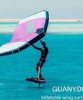 Person using Inflatable Wing Foil With Handheld Wing Kite Surf Wing For Water Sports Wind Wing Foil Setup in ocean