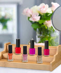 Expandable 3 Tier Bamboo Spice Rack And Kitchen Cabinet Organizer Fits Standard Jars Horizontally with nail polish bottles on display.