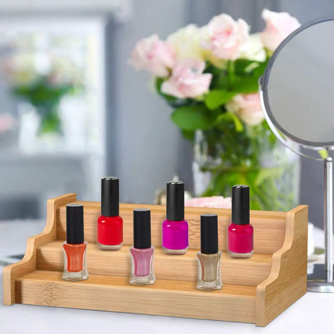 Expandable 3 Tier Bamboo Spice Rack And Kitchen Cabinet Organizer Fits Standard Jars Horizontally with nail polish bottles on display.
