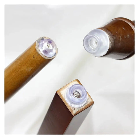 Three chair legs with 100 Pieces Durable Thermoplastic Rubber Feet With Screws For Cutting Boards And Furniture Transparent Chair Leg Pads installed.