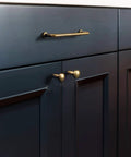 Close-up of 6 Pack 6 5/16 Inch Center-To-Center Antique Brass Cabinet Bar Pulls Old-School Vintage Drawer Handles on dark cabinet