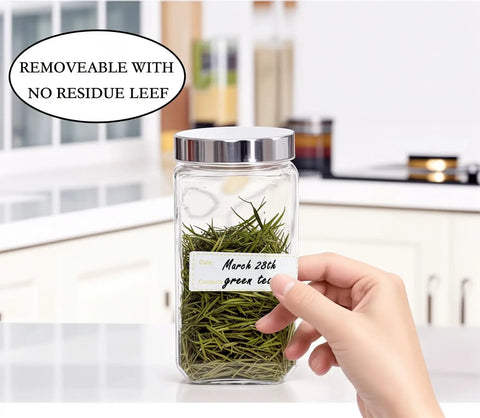 Hand holding jar with Freezer Labels 375 Pcs Self Adhesive Write On Removable 3 Rolls No Fuss 3x1 Inch Tape For Containers