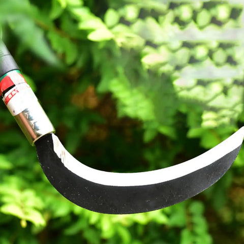 Two Pack Manganese Steel Weeding Sickle Set For Easy Yard Work, Weed Cutting And Harvesting with ergonomic handle shown against leaves