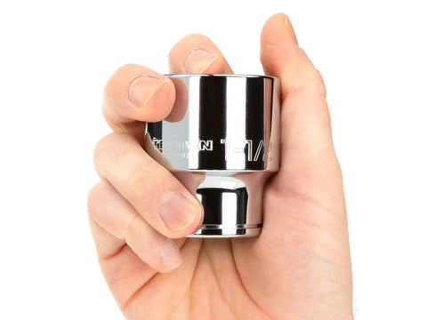 Hand holding socket from 3/4 Inch Drive 21 Piece 12 Point Socket Set From 3/4 To 2 Inches Durable Chrome Moly Steel For Auto And Home Projects