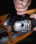 Close-up of No Hassle Heavy Duty Cordless Angle Grinder With 20 Volt Lithium Ion Battery cutting through metal pipe.