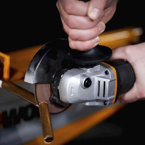 Close-up of No Hassle Heavy Duty Cordless Angle Grinder With 20 Volt Lithium Ion Battery cutting through metal pipe.