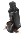 Top Shelf Variable Speed Espresso Coffee Grinder With 80mm Stainless Steel Flat Burrs For Hella Sharp Grinds And Drip Ready Brewing Action In Sleek Black Frame, featuring a black design and ground coffee in hopper.
