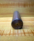 Close-up of Rexroth Bosch 1 Inch Pivot Pin R433012623, 3.5 inch length, on wooden surface for machinery applications.