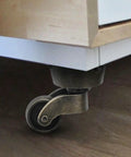 Installed two pack vintage zinc alloy swivel caster wheels with antique green bronze finish under furniture piece