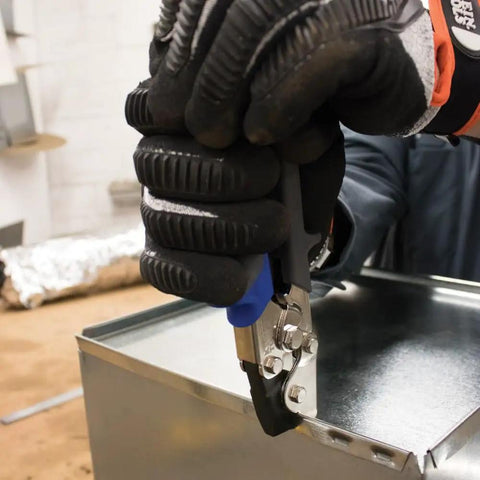 Worker using Punch Set Snap Lock Handy Tool For Sheet Metal, Vinyl And Aluminum Siding, Creates Three Eighths Inch Impressions.