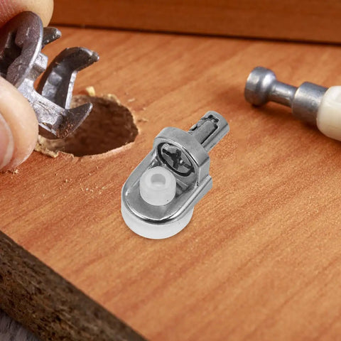 24 Pack Zinc Alloy Shelf Support Pegs For Cabinets And Cupboards, close-up of a silver peg being installed on a wooden surface.