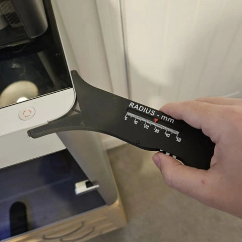 Slick Sliding Radius Gauge With A Solid Ergonomic Grip And Dang Accurate Engraved Scale For Quick Drafting And Hardwood Joinery Projects Plus Rustproof Finish For Daily Shop Grind in use measuring a curve on a surface.