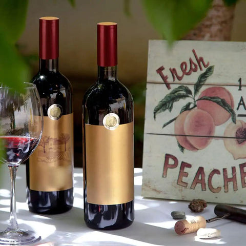 Premium Heat Shrink Wine Bottle Caps 100 Pack Flexible PVC Sealing Film on red-capped wine bottles with glass of red wine.