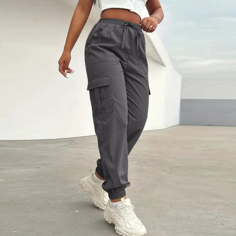 Woman wearing Women Lightweight Quick Dry Cargo Hiking Pants With High Waist Fit All Day Comfort Stretchy Parachute Style Baggy Travel Joggers For Camping Fishing Running Gym And Outdoor Adventures.