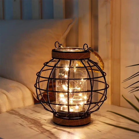 Battery Powered Metal Cage LED Lantern 7.3 Inch Tall Cordless Accent Light With 20 Fairy Lights on a tabletop indoors