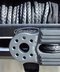 Close-up of FlatLink Folding Winch Shackle Bracket For 4x4 Off Road Builds, Ultra Low Profile Mount in a silver finish, mounted on a winch.