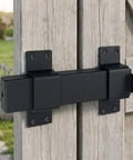 Built Tough As Nails Adjustable Slide Gate Latch 2 Pack installed on wooden door, black coated steel finish for yard security.