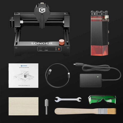LONGER Ray5 mini laser engraver with 140x130 mm engraving area, black frame; includes power supply, USB cable, manual, goggles.