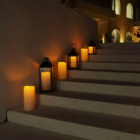 Large 4x10 Waterproof Outdoor Flameless Candles Battery Operated LED Pillar Lights illuminating outdoor stairs in lanterns at night